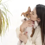 woman giving her cute dog kiss 3074 3583 1695897670