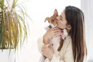 woman giving her cute dog kiss 3074 3583 1695897670